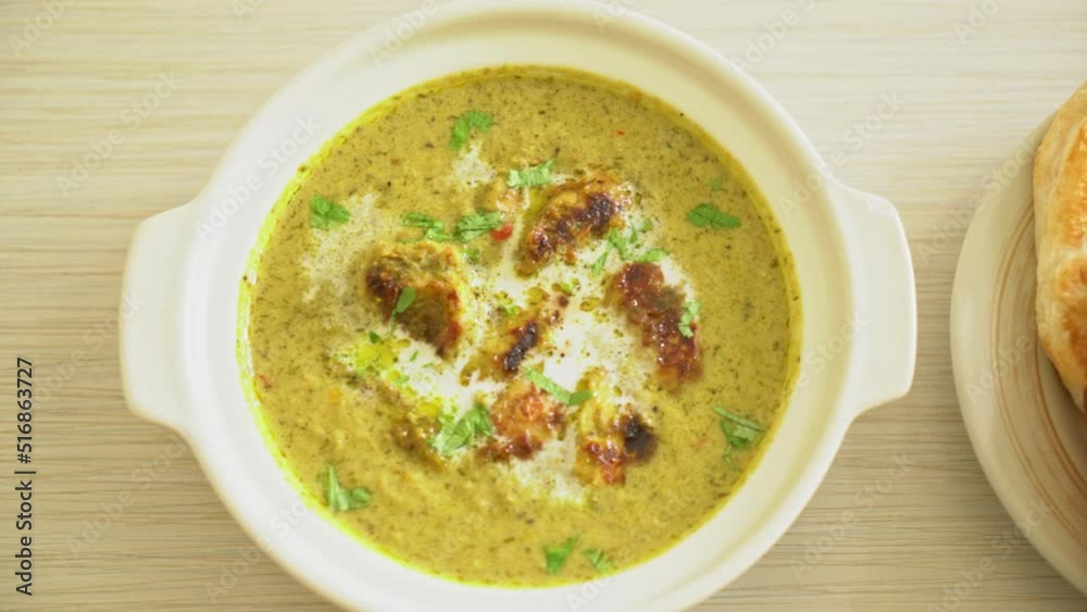 Afghani chicken in green masala curry or Hariyali tikka chicken hara masala with roti or naan bread - Indian food style Afghani chicken in green masala curry or Hariyali tikka chicken hara masala with roti or naan bread - Indian food style