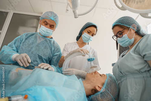 Well-trained anesthesiologist follows the patient during the surgery in clinic