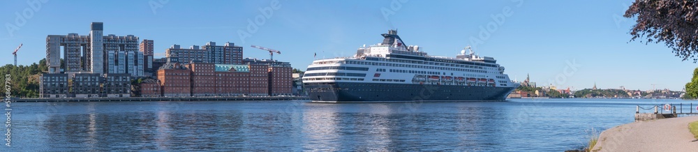 A cruise ship arriving between the apartment islands Kvarnholmen and Djurgården, a sunny summer day in Stockholm