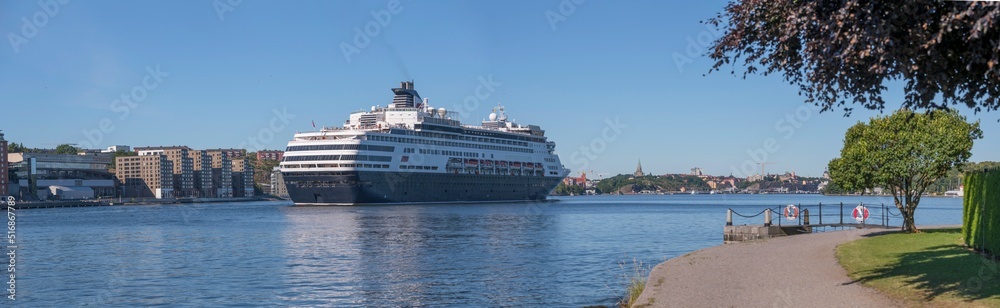 A cruise ship arriving between the apartment islands Kvarnholmen and Djurgården, a sunny summer day in Stockholm