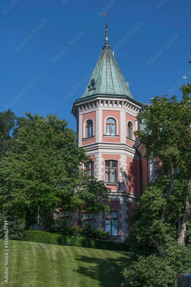 Obraz premium A mansion pink tower in the island Djurgården, a sunny summer day in Stockholm Sweden 2022-07-12