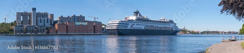 Fototapeta Naklejka Na Ścianę i Meble -  A cruise ship arriving between the apartment islands Kvarnholmen and Djurgården, a sunny summer day in Stockholm