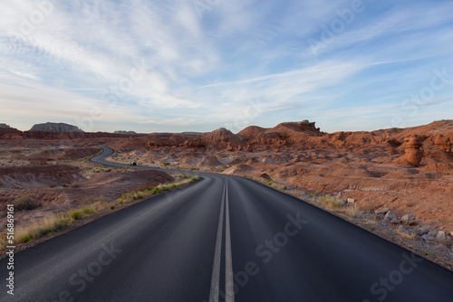 Scenic Road surrounded by Red Rock Mountains in the Desert. Spring Season. Goblin Valley State Park. Utah, United States. Nature Background.