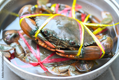 fresh mud crab for cooking food in the seafood restaurant, raw crab on pot in the market