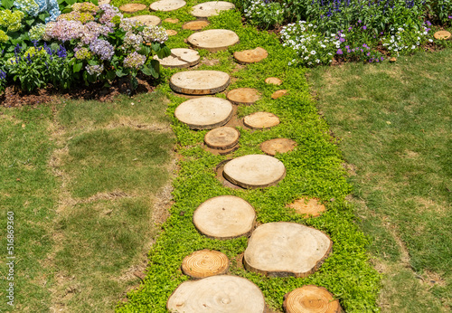 Walkway in the park garden made of round saw cuts of tree trunks photo