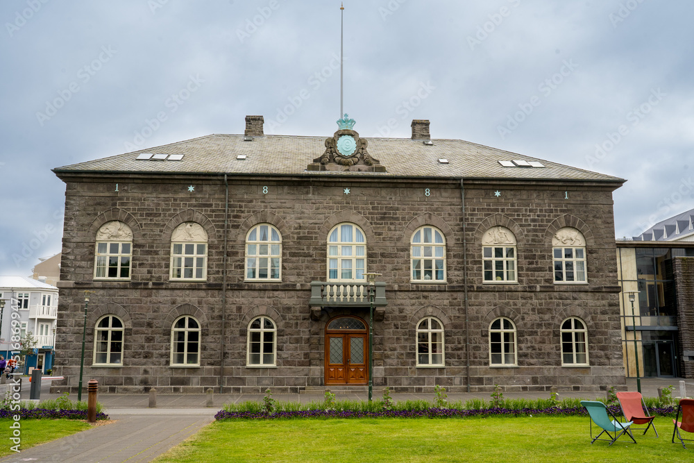 Reykjavík, Iceland - July 4, 2022 a horizontal view of the Althingi Parliament House, a classical 19th century structure which stands by Austurvöllur in central Reykjavík, Iceland.