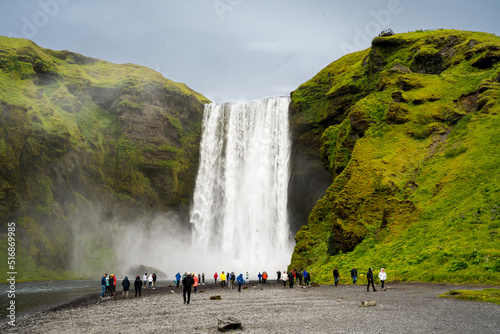 Obraz na płótnie Skógar, Iceland - July 3, 2022 A view of Skógafoss, a waterfall on the Skógá River in the south of Iceland at the cliff marking the former coastline. w salonie