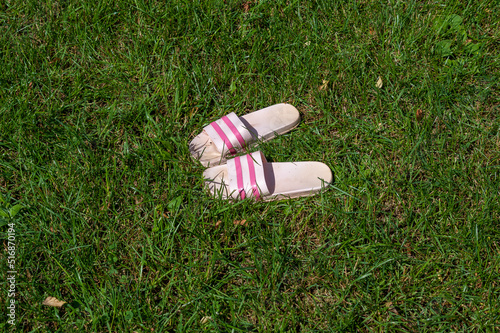 Women's slippers are on the grass