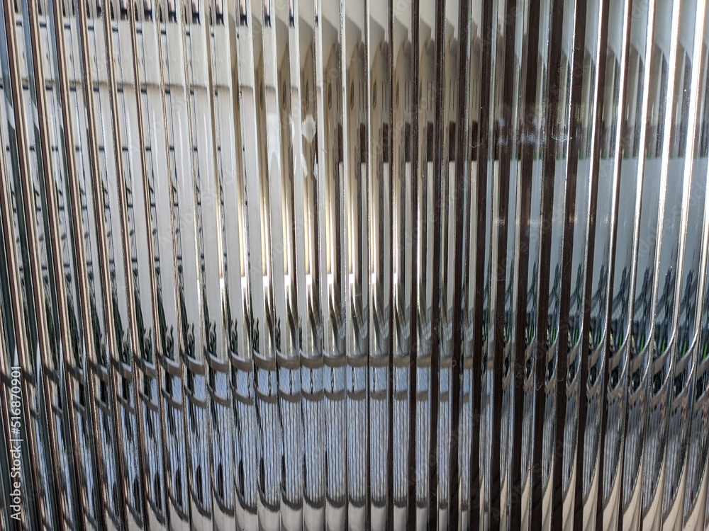 Curved glass background with textured stripes or wavy close up in detail Curved glass background with textured stripes or wavy close up in detail
