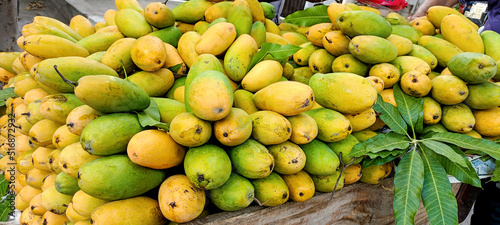 Heap of fresh ripe yellow mangoes background