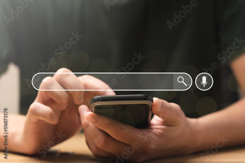 Search Engine Concept. Tools or programs for searching for information on the Internet. Man's hand using mobile phone to search for information using Search Engine and help your online business grow.