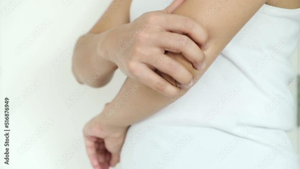 Woman has elbow pain. She squeezes massage, relieves pain from tendon and bone injuries. from sports concept and health care Woman has elbow pain. She squeezes massage, relieves pain from tendon and bone injuries. from sports concept and health care