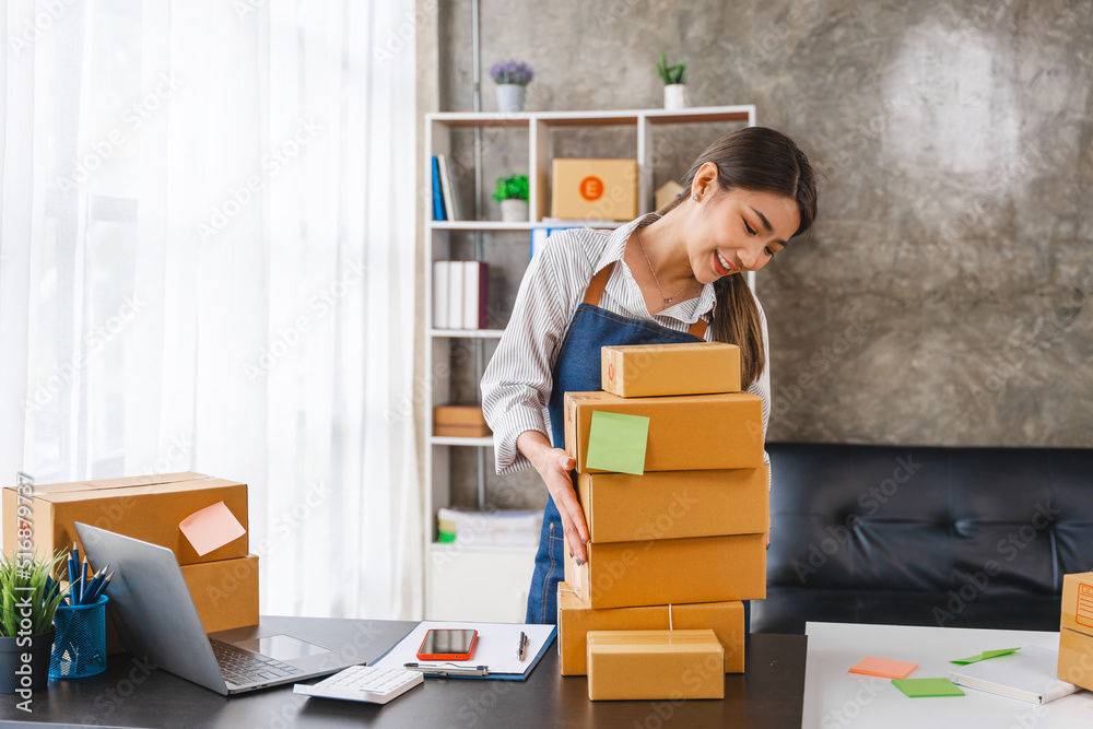 Entrepreneurs Small Business SME, Young Asian women happy after a new order from the customer, business owner working at home office. Entrepreneurs Small Business SME, Young Asian women happy after a new order from the customer, business owner working at home office.