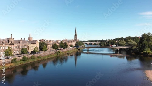 Drone descending above river Tay revealing beautiful reflection of St. Matthew's Church of Scotland. Perth, United Kingdom. photo