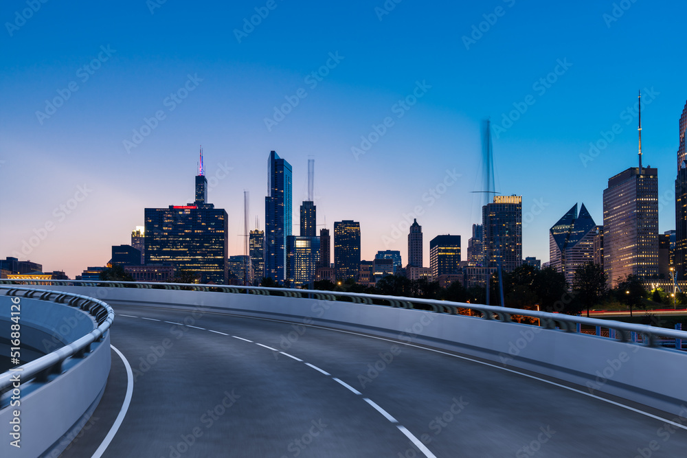 Empty urban asphalt road exterior with city buildings background. New modern highway concrete construction. Concept of way to success. Transportation logistic industry fast delivery. Chicago. USA. Empty urban asphalt road exterior with city buildings background. New modern highway concrete construction. Concept of way to success. Transportation logistic industry fast delivery. Chicago. USA.