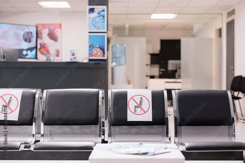 Fototapeta premium Nobody in empty hospital reception waiting area, medical facility with healthcare service to cure patients with disease. No people in clinic lobby waiting room during covid 19 pandemic.