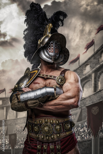 Tableau sur toile Shot of muscular gladiator dressed in armor and helmet posing with crossed arms in arena