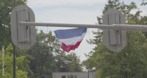 240 fps slow motion Upside down Dutch flag hanging on traffic light. A sign of the Dutch farmer protests which are happening all over the Netherlands photo