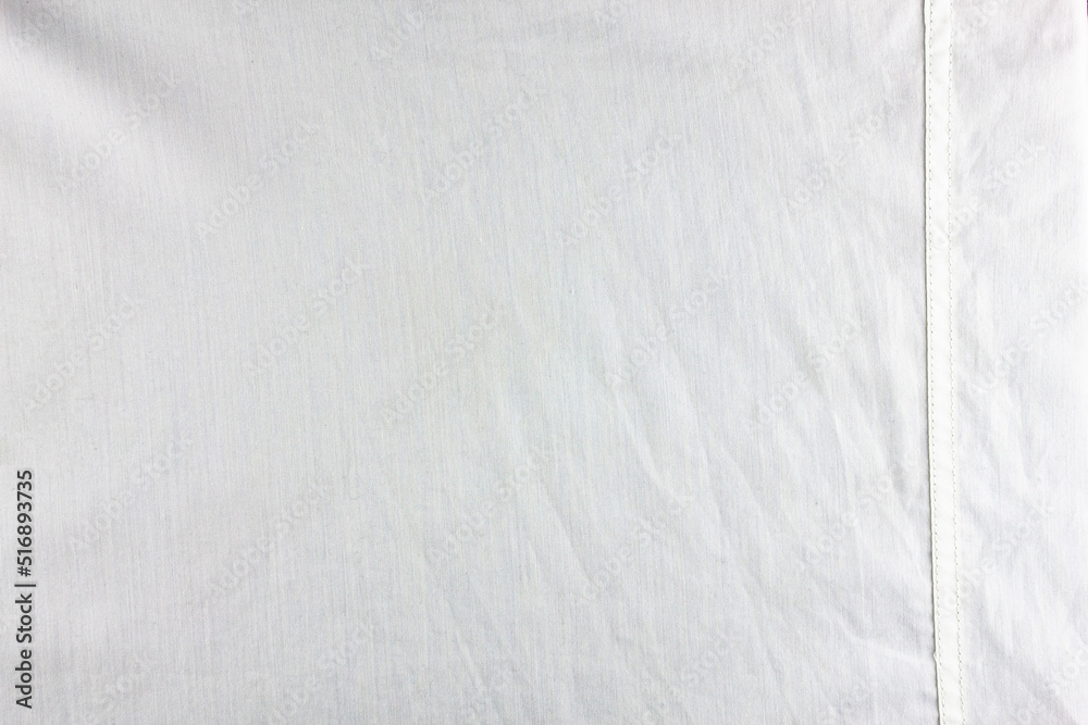White fabric with a stitched strip.Material cotton white tailoring. High definition white cotton fabric texture. White fabric with a stitched strip.Material cotton white tailoring. High definition white cotton fabric texture.