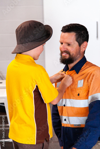 Helping to do up button on shirt before school photo