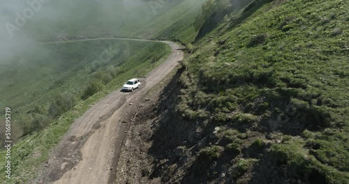 AERIAL - Car driving down the Tskhratskaro Pass, Georgia, forward shot photo