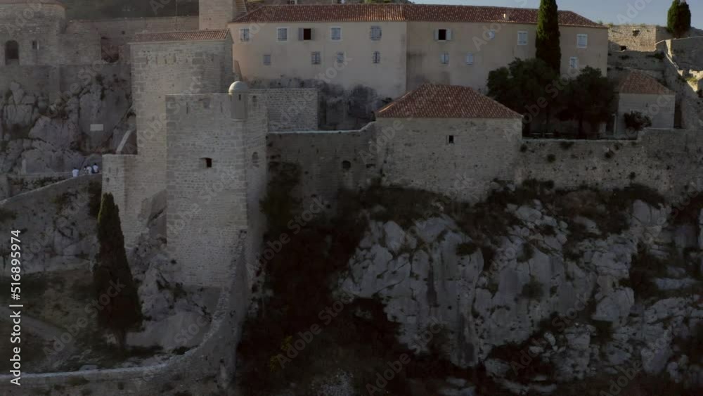 Medieval Fortress Of Klis In Croatia - aerial sideways Medieval Fortress Of Klis In Croatia - aerial sideways