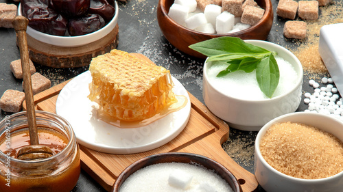 Various diet replacement for sugar on dark background.
