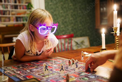 Girl playing board game with her father photo