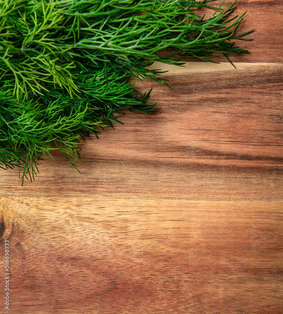 a bunch of green dill on a wooden background with blank space for text, concept of fresh vegetables and healthy food a bunch of green dill on a wooden background with blank space for text, concept of fresh vegetables and healthy food