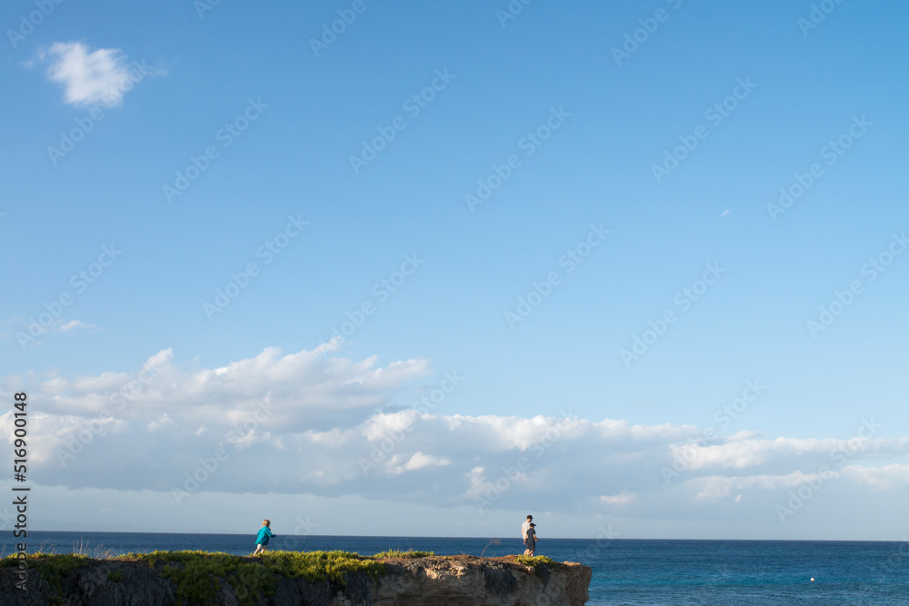 Family on cliff by sea