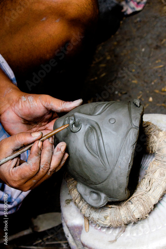 Creating clay head of goddess Durga in Kumartuli, Calcutta, India. The idols are made for the Hindu festival of Durga Puja also known as Dassera