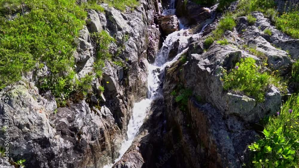 Idyllic mountain river at Swiss mountain pass Susten on a sunny summer day. Slow motion movie shot July 13th, 2022, Susten Pass, Switzerland.
