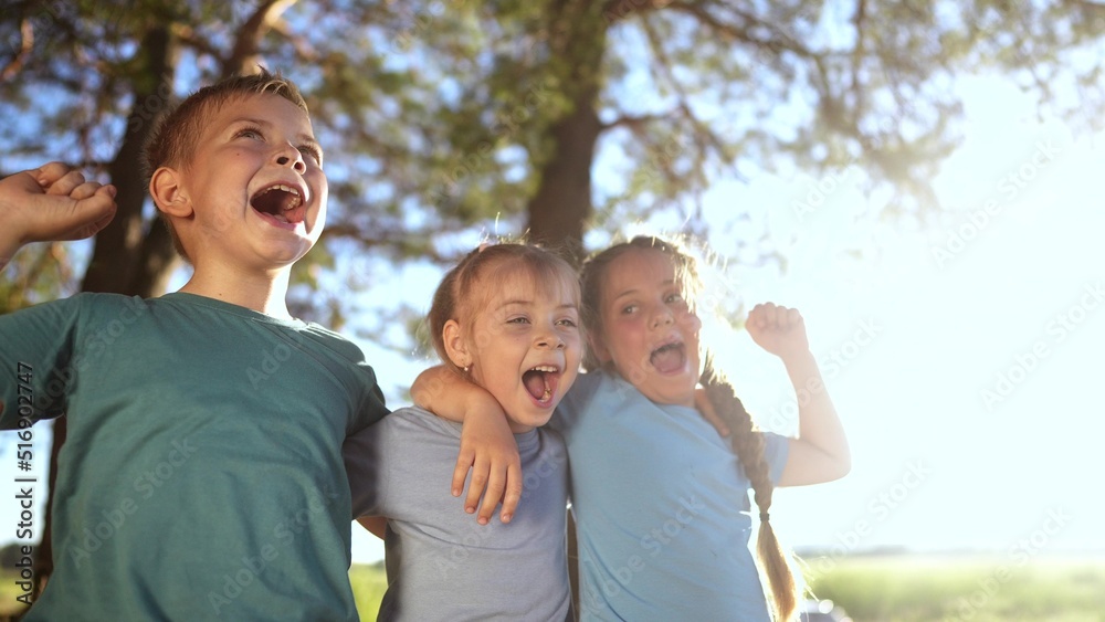 group of happy kids in the park. a team of small children hugging rejoice shouting fun in the forest park. happy family victory kid concept. a group of kids rejoice in victory dream in forest park group of happy kids in the park. a team of small children hugging rejoice shouting fun in the forest park. happy family victory kid concept. a group of kids rejoice in victory dream in forest park