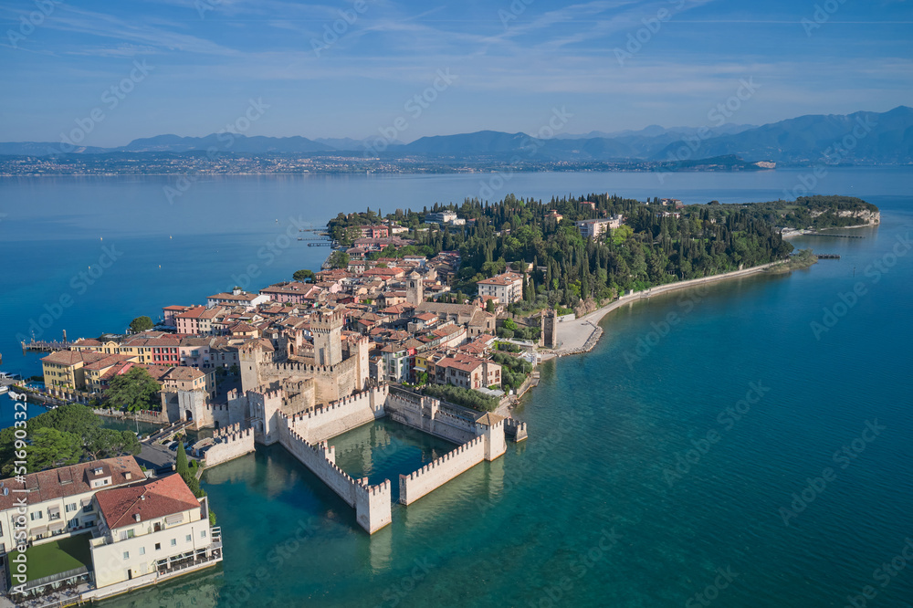 Aerial photography with drone, Rocca Scaligera Castle in Sirmione. Garda, Italy. Popular travel destination on Lake Garda in Italy. Scaligero Castle drone view. Sirmione top view.