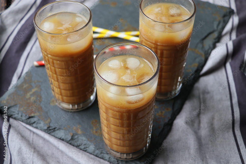 Summer drink iced coffee in tall glass on rustic wooden background. Selective focus Summer drink iced coffee in tall glass on rustic wooden background. Selective focus
