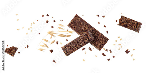 Tasty healthy bars from whole oat grain and chocolate  with crumbs and spikelets flying isolated on white background.