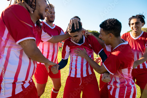 Multiracial male soccer team screaming while celebrating goal during match at playground © wavebreak3