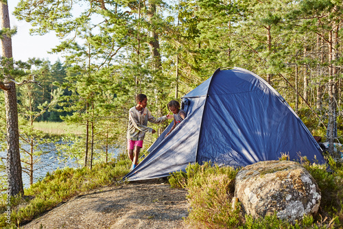 Siblings camping in forest photo