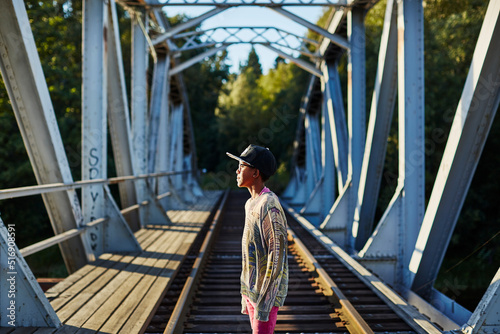 Boy in baseball cap on bridge photo