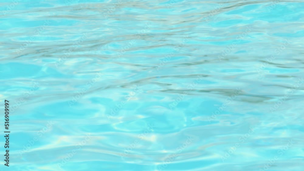 defocused 4k real time video water pool waves,windy summer sunny day.travel vacation concept,swimming in blue water pool.sea beach,tanning