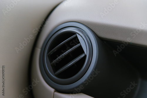 Elements of an automobile air conditioner. Details of the front panel of the car with air diffusers. Beige interior of the car. © Cherkasova Alie