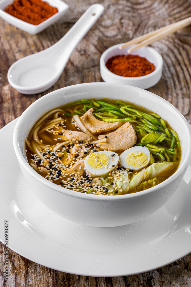 Soup with boiled egg, noodles, salad, green onions, and sesame seeds Soup with boiled egg, noodles, salad, green onions, and sesame seeds