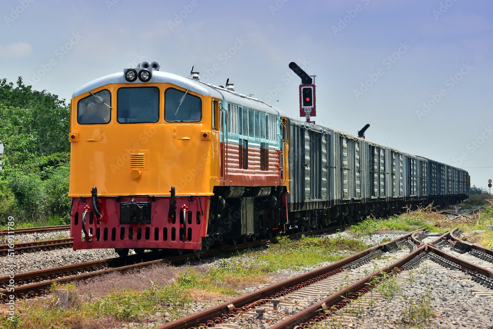 Freight train by diesel locomotive on the railway in Thailand Freight train by diesel locomotive on the railway in Thailand