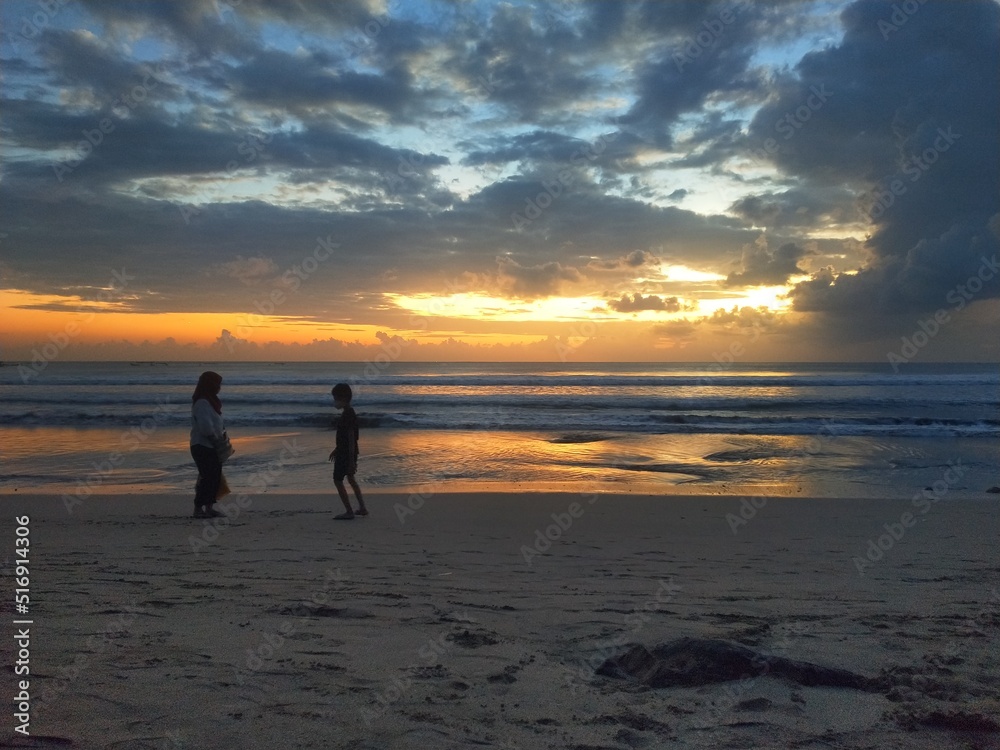 Silhouette photo with sunset on Kuta beach Bali