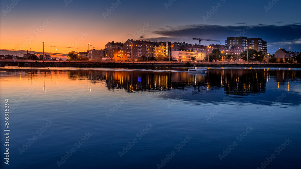Buildings by sea at sunset Buildings by sea at sunset