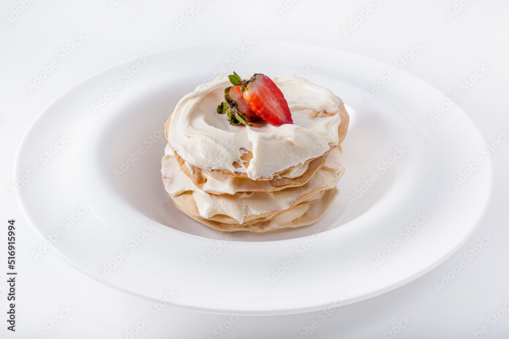 Pancakes with white cream and strawberries Pancakes with white cream and strawberries