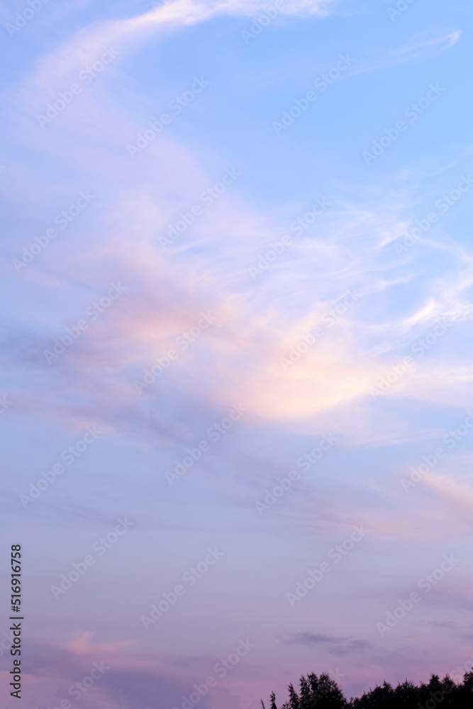 Romantic sunset sky background with soft clouds. Sunset light colors clouds in red, blue, pink and purple.