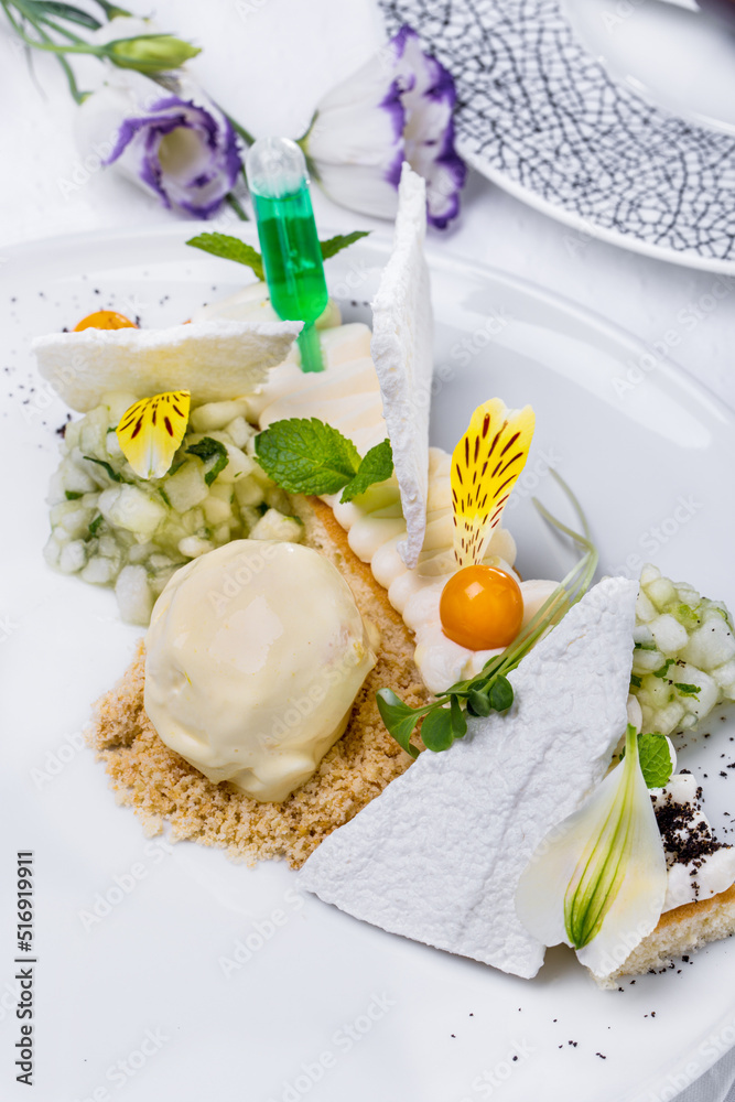 Sweet dessert with flower petals, white chips, ice cream scoop, mint, cream and physalis Sweet dessert with flower petals, white chips, ice cream scoop, mint, cream and physalis