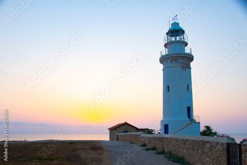 Beautiful sunset on coastline of Kato Paphos. The lighthouse in ancient complex park Kato Paphos.