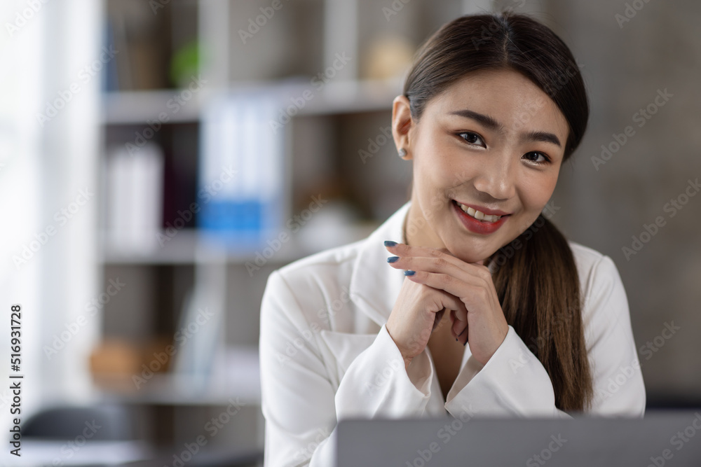 Business of Asian woman or accountant working on calculator to calculate business data, accounting document, and laptop computer at home office, business finances and calculate concept Business of Asian woman or accountant working on calculator to calculate business data, accounting document, and laptop computer at home office, business finances and calculate concept
